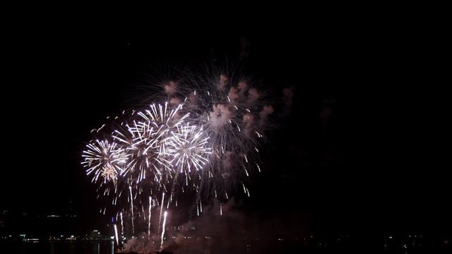 Real fireworks exploding celebration frame fill and loop seamlessly abstract blur bokeh lights in the night sky with the glowing fireworks show festival. 4K 25fps