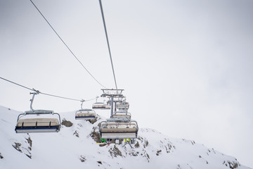 Photo of cableway among snowy hills