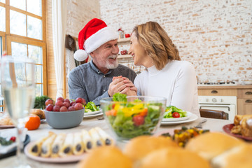 Cheerful mature people celebrating Christmas at home