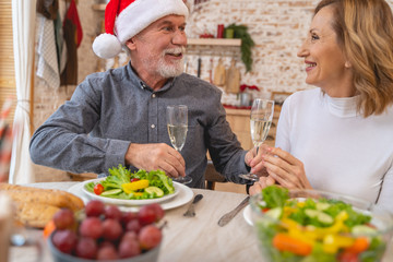 Positive delighted senior family having festive dinner