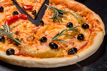Tasty fresh hot pizza against a dark background. Pizza, food, vegetable, mushrooms