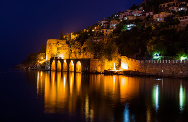 Fototapeta premium Night view of harbour, fortress and ancient shipyard in Alanya, Turkey
