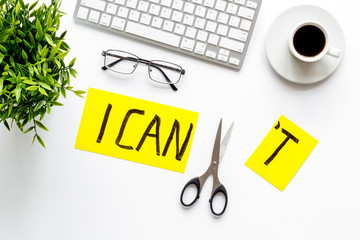 Motivation to be confident. Cut text I can't near scissors on white office desk