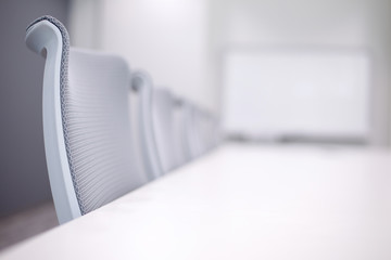 Empty business conference room interior in selective focus on chair