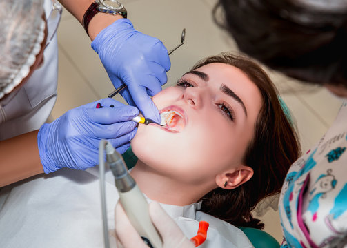Dentist and his assistant carrying out a thorough examination (real treatment)