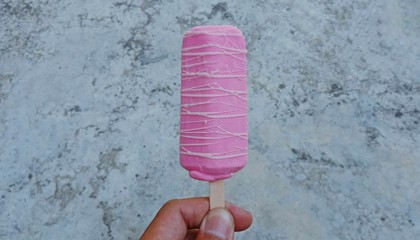 ice cream strawberry coating sugar on the abstract gray vintage blank background. with selective focus