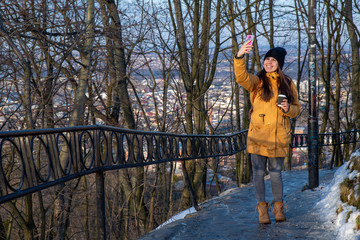 young pretty woman drinking coffee outdoors copy space