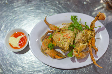 Crunchy grilled crab on the plate served with chili sauce