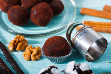 Christmas chocolate truffles and spices on shabby chic blue wood table
