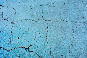 Texture of a concrete wall with cracks and scratches which can be used as a background