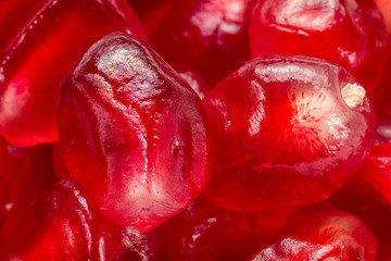 Ripe pomegranate seeds close up. Natural fruit background. Macro view.
