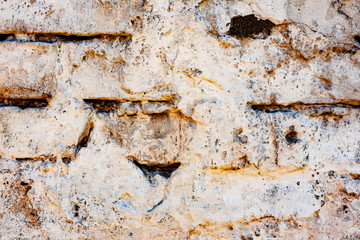 Texture of a brick wall with cracks and scratches which can be used as a background