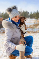 Obraz premium Woman playing with dogs during winter