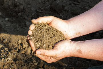 A close up view on plowed soil in mans hands