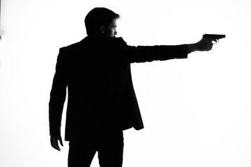silhouette of man with gun