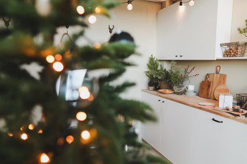 Festive kitchen in Christmas decorations. Christmas dining room. Beautiful New Year decorated classic home interior. New Year and Christmas background
