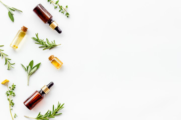 Essential oils and fresh herbs on white background top view pattern frame copy spacee - obrazy, fototapety, plakaty