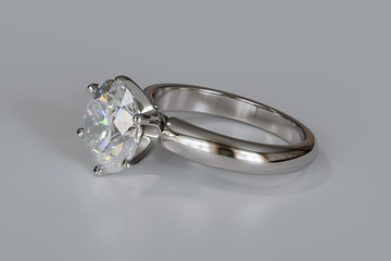 Solitaire diamond engagement ring on white background.