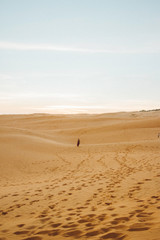 Girl standing in desert.