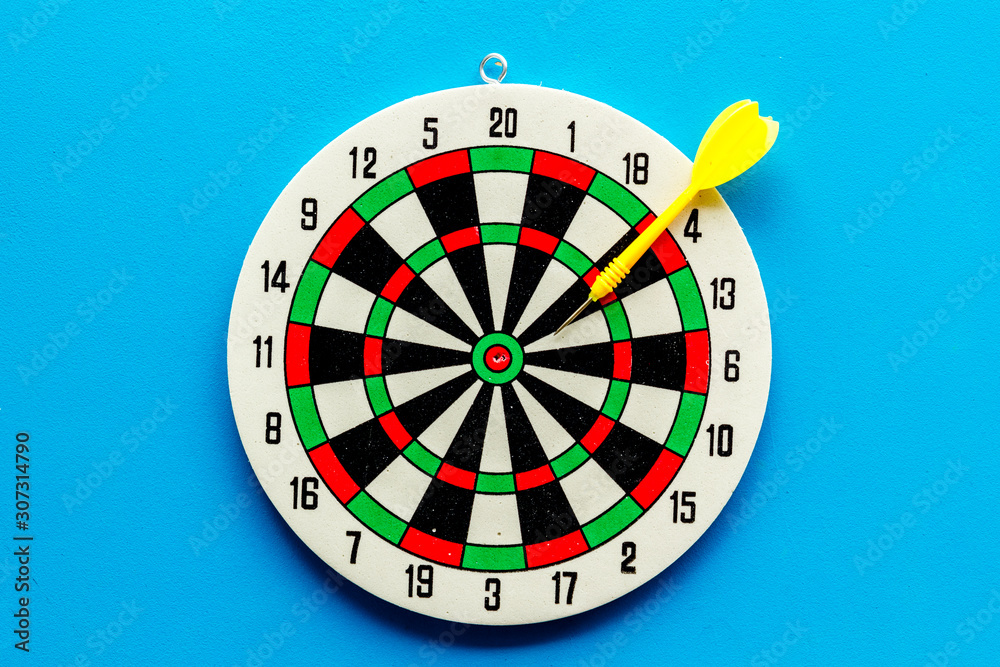 Wall mural goal achievement concept. dartboard and arrows or dart on blue background top view copy space