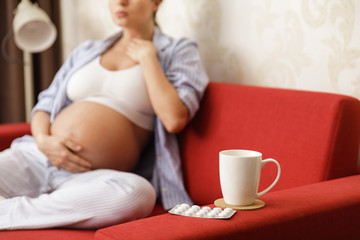 Young pregnant woman with a sore throat