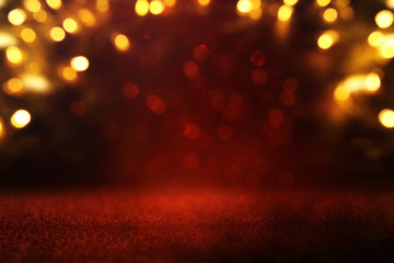 background of abstract red, gold and black glitter lights. defocused
