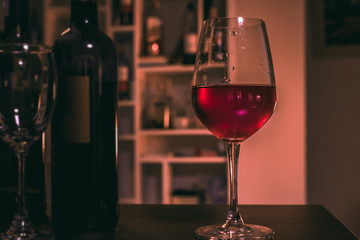 a glass of wine on wood bar, soft focus.