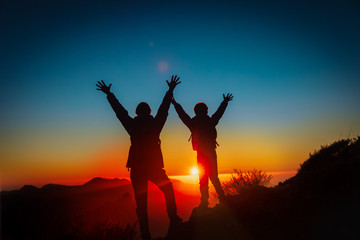 Father and son travel in sunset mountains, family hiking