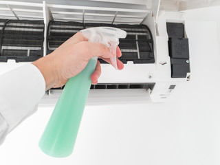 Modern airconditioner unit service cleaning the filter to prevent respiratory disease.