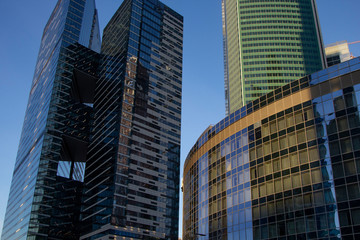 Naklejka premium Modern skyscrapers in business district in evening light at sunset