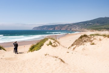 Fototapeta na wymiar Praia do Guincho is a popular Atlantic The beach, has preferred surfing conditions and is popular for surfing, windsurfing, and kitesurfing. Strong northern winds are predominant during summer time