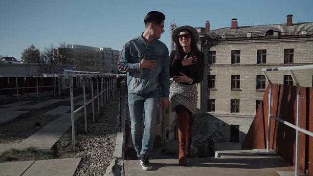 A guy and a girl climb the steps to the roof - teras