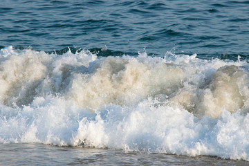 Waves crashing the beach and rocks