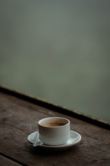A cup of coffee on the terrace with view of forest.