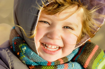 beautiful little girl on the beach in winter
