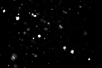 Texture of falling snow, volumetric snow bokeh on a black background