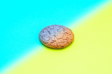 oatmeal cookies on a colored background. concept of two opinions.