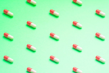 pattern of pills on a colored background. medication side effects concept.