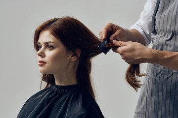 Fototapeta premium hairdresser cutting hair with scissors