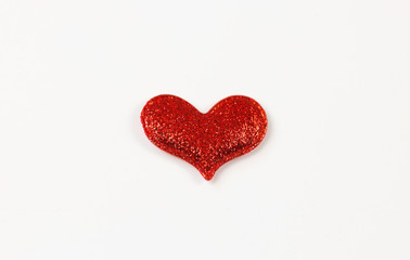 Red glitter heart on white background