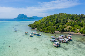 Aerial view of Sea Gypsy water village, island and the ocean with sky in Semporna, Sabah, Malaysia, Borneo.