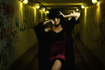Fototapeta na wymiar Strange and freaky woman in the dark tunnel