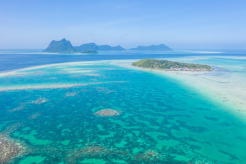 Aerial view of Sea Gypsy water village, island and the ocean with sky in Semporna, Sabah, Malaysia,...