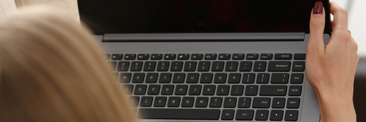 young woman hold laptop in arms work