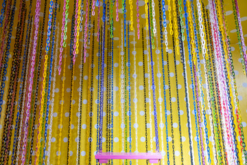 Close up of colorful swing in a children's indoor play area.