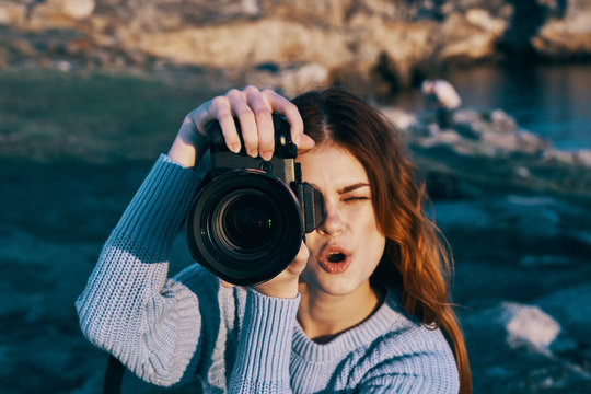 young woman taking photo with digital camera
