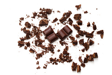 Chocolate crumbs with slices. Crushed chocolate on a white background