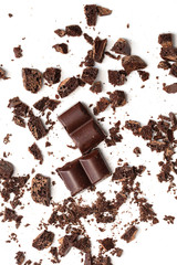 Vertical chocolate chips with slices. Crushed chocolate on a white background