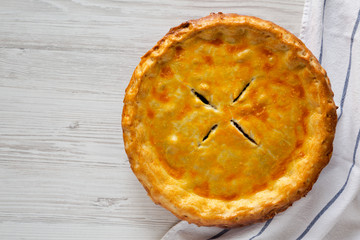 Delicious homemade Canadian Tourtiere Meat Pie on a white wooden table, top view. Flat lay, overhead, from above. Copy space.