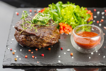 juicy beef steak with ketchup and pickled vegetables